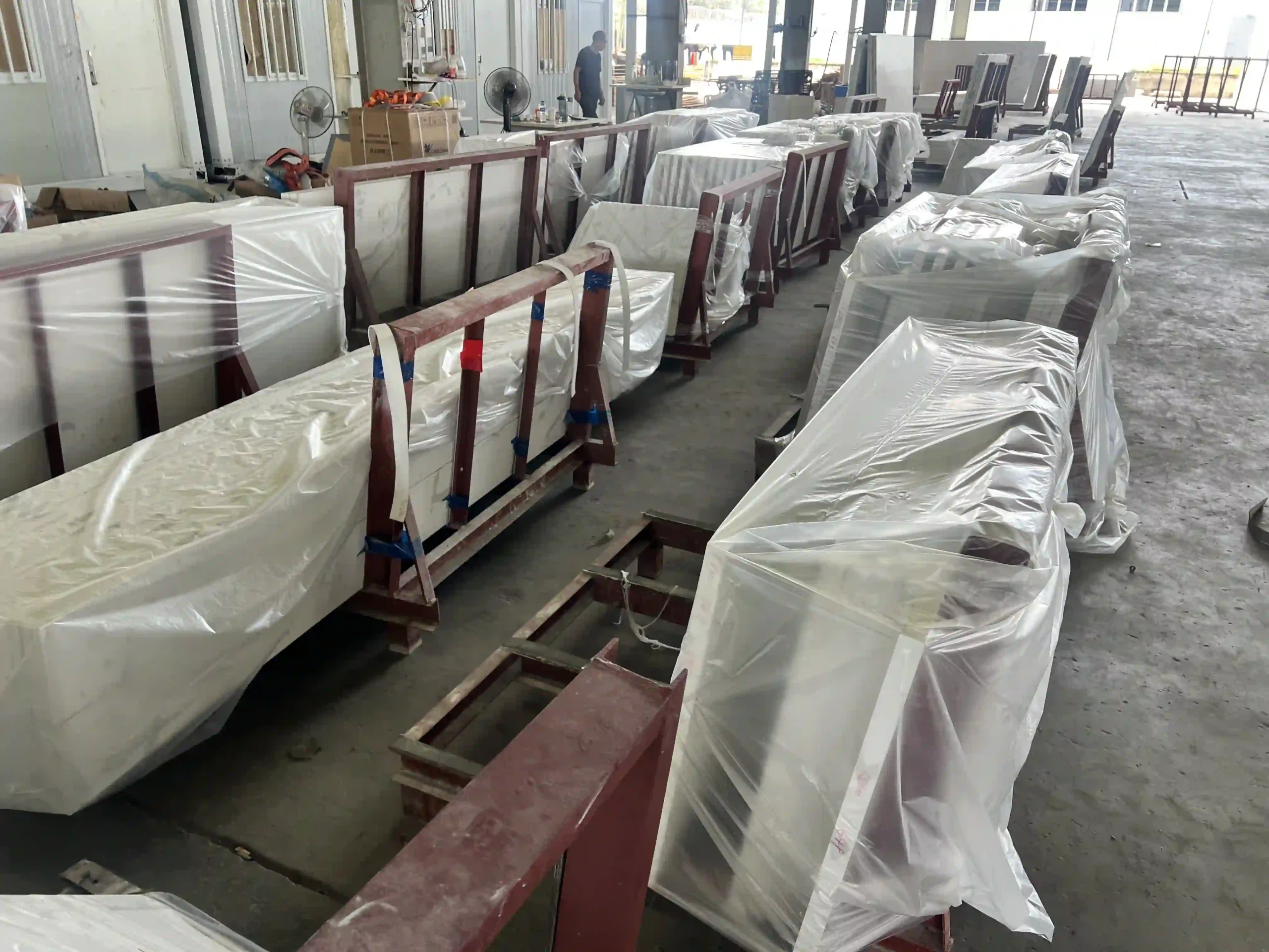 Quality check of a long white quartz countertop in the workshop