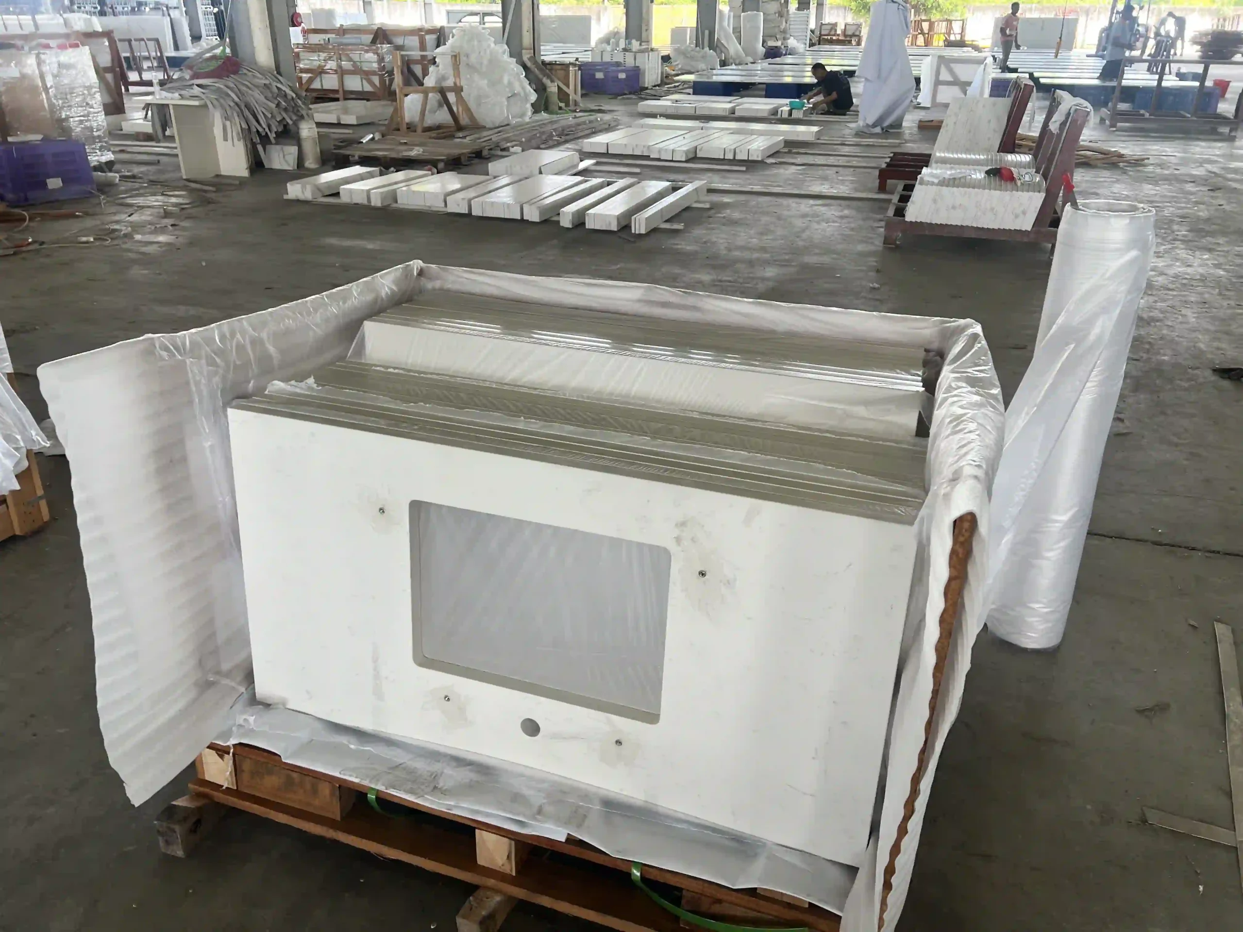 Stacked white quartz countertops with fabricated rectangular cutouts
